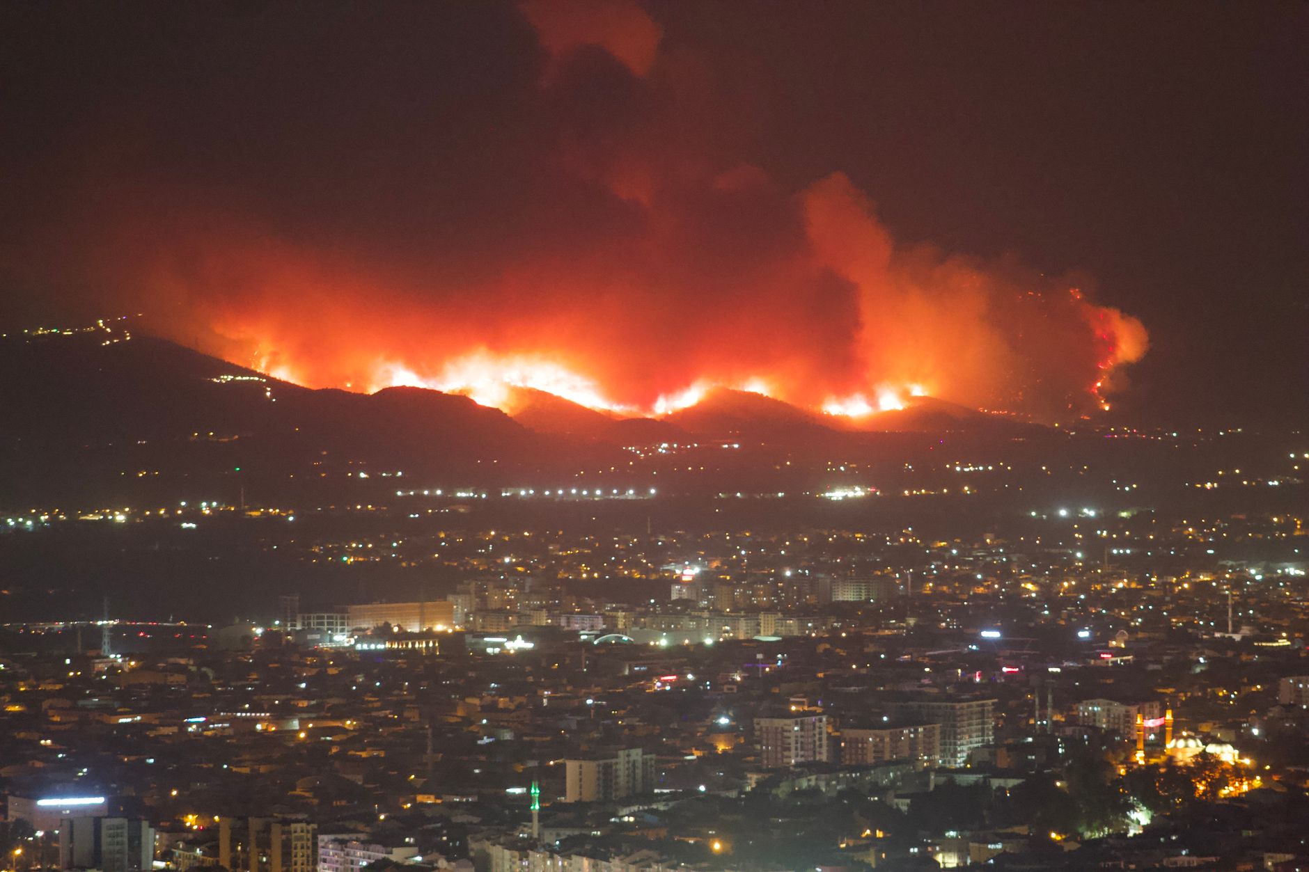 Wildfire smoke over a mountain landscape, illustrative image
