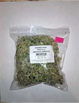 Photograph of zip lock bag containing broccoli sprouts with label for Evergreen Fresh Sprouts, LLC. Broccoli Sprouts, 4 oz.