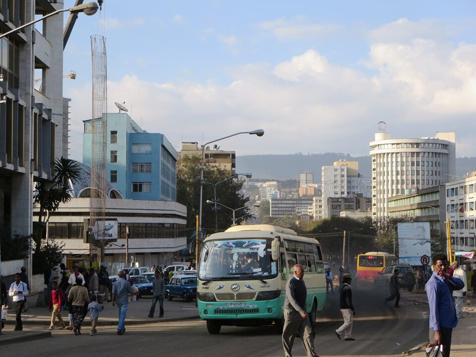 Street-level photo: Gambia Street in downtown Addis Ababa, Ethiopia, bustles with traffic.